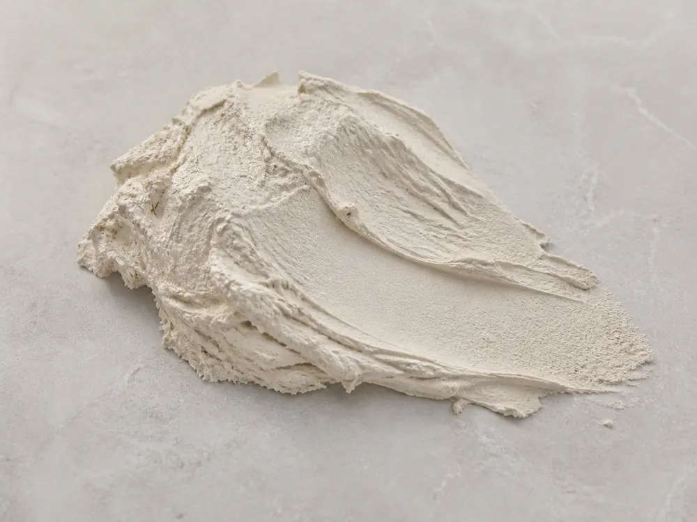 Realistic creamy wall putty sample on a neutral mineral surface